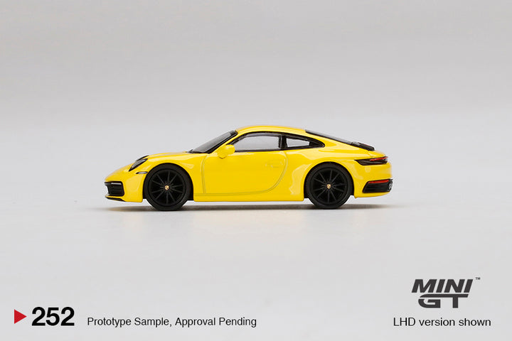 Mini GT 1:64 Porsche 911 (992) Carrera 4S Racing Yellow MGT00252-L Side